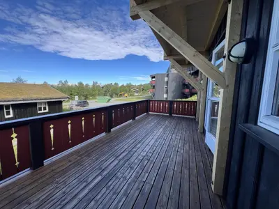 a large deck with a view of the water at Spacious Apartment For Up To 5 Guests in Beitostøl
