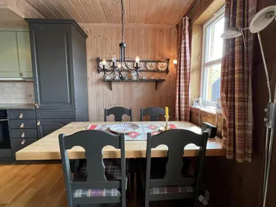 a dining room with a wooden table and chairs at Spacious Apartment For Up To 5 Guests in Beitostøl