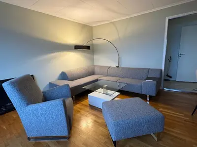 a living room with a couch and two chairs and a table at Apartment with a beautiful view in the center of Ålesund in Ålesund