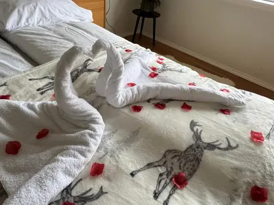 a bed with a towel with a deer on it at Apartment with a beautiful view in the center of Ålesund in Ålesund