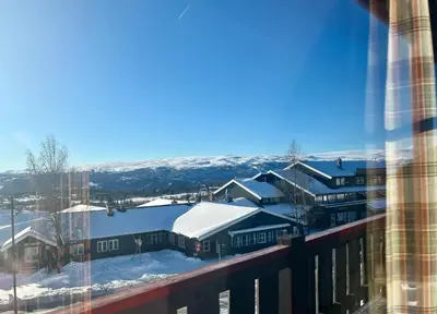 a view from a balcony of snow covered buildings at Leilighet midt i sentrum in Beitostøl