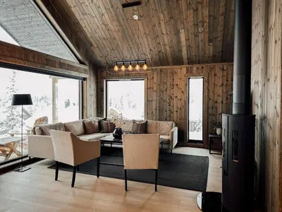 a living room with a couch and a fireplace at Modern Mountain Cabin - Sauna - 5 Bedrooms - Sleeps for 10 in Torpo