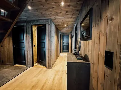 a hallway with wooden walls and wooden floors at Modern Mountain Cabin - Sauna - 5 Bedrooms - Sleeps for 10 in Torpo