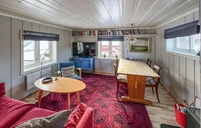 a living room with a couch and a table at Gorgeous Home In Svingvoll in Svingvoll