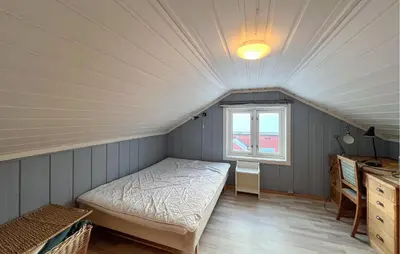 a bedroom with a bed in a room with a window at Gorgeous Home In Svingvoll in Svingvoll