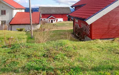 a red barn with a red roof in a field at Gorgeous Home In Svingvoll in Svingvoll