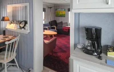 a kitchen and a living room with a table at Gorgeous Home In Svingvoll in Svingvoll