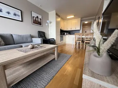 a living room with a couch and a table at Bright, Homey Apartment In Beitostølen Center in Beitostøl