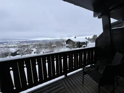 a balcony with a view of a snow covered yard at Bright, Homey Apartment In Beitostølen Center in Beitostøl