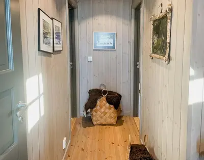 a hallway with a door and a bag on the floor at Enjoy The Calm Setting Of This Cozy Family Cabin in Etnedal