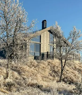 a house on top of a hill with trees at Enjoy The Calm Setting Of This Cozy Family Cabin in Etnedal