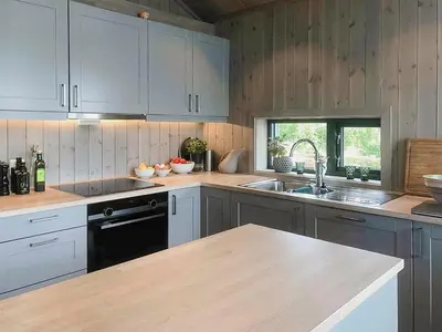 a kitchen with white cabinets and a sink at Enjoy The Calm Setting Of This Cozy Family Cabin in Etnedal