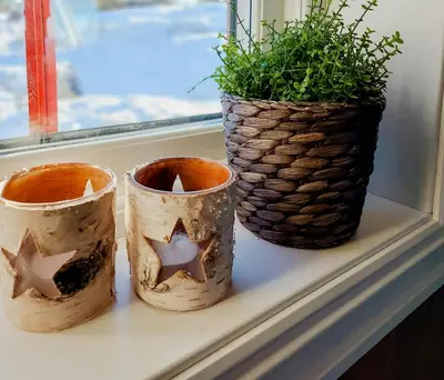 three pots sitting on a window sill with a plant at Fantastic View Cabin In Peaceful Blefjel in Lampeland