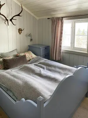 a large bed in a bedroom with a window at Traditional Cabin In Gålå With Stunning Nature in Gålå