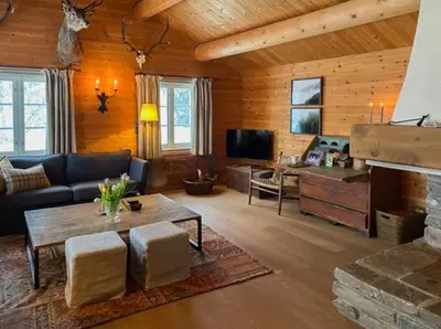 a living room with a couch and a table at Traditional Cabin In Gålå With Stunning Nature in Gålå