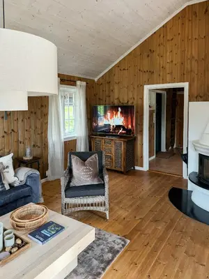 a living room with a couch and a tv at Panoramic Cabin With Fjord Views In Valldal in Valldal