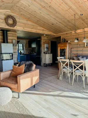 a living room with a couch and a table at Cozy Modern Mountain Cabin At Kvamsfjellet in Kvam