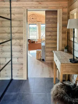 a room with a door leading to a bedroom at Cozy Modern Mountain Cabin At Kvamsfjellet in Kvam