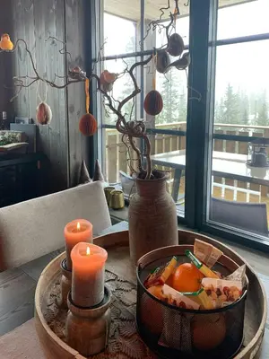 a table with a bowl of food and candles on it at Ski-In Ski-Out Apartment In Trysil in Trysil