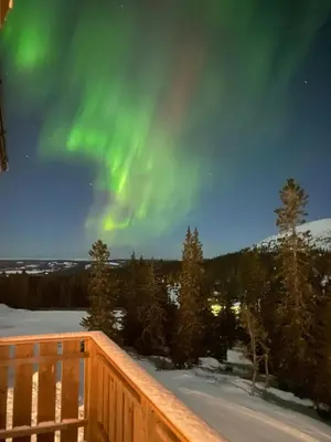 a view of the aurora from the deck of a house at Ski-In Ski-Out Apartment In Trysil in Trysil