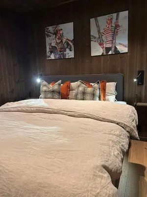 a bedroom with a large bed with two pictures on the wall at Ski-In Ski-Out Apartment In Trysil in Trysil