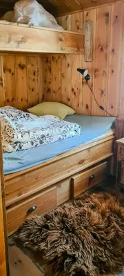 a bedroom with a bed with a wooden frame at Cozy Cabin With A Beautiful View in Øygardsgrend