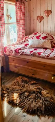 a bedroom with a bed with a wooden floor at Cozy Cabin With A Beautiful View in Øygardsgrend