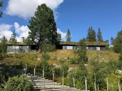 a house on top of a hill with stairs at Mountain Cabin With Views And Close To Ski Trails in Aurdal