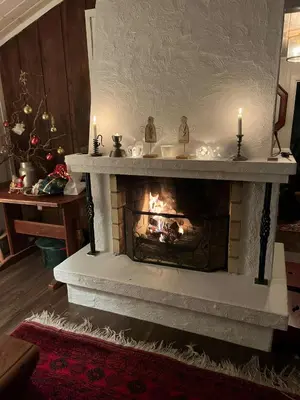 a fireplace with two candles in a living room at Mountain Cabin With Views And Close To Ski Trails in Aurdal