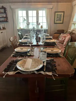 a dining room table with plates and glasses on it at Mountain Cabin With Views And Close To Ski Trails in Aurdal
