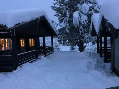 a cabin in the snow at night at Mountain Cabin With Views And Close To Ski Trails in Aurdal