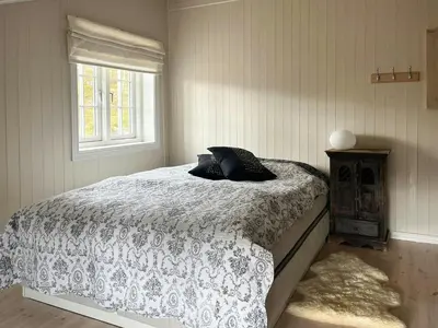 a bedroom with a bed and a window at Designer Cabin With Panoramic Views In Hovden in Bykle