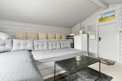 a living room with a couch and a table at Peaceful Cabin With View And Jacuzzi At Blefjell in Kongsberg