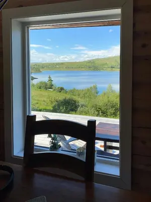 a window with a view of a lake at Mountain Cabin By Hundsåvatnet With Large Veranda in Søvassli