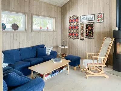 a living room with a blue couch and a table at New Cabin With Mountain View In Bittermark, Trysil in Trysil