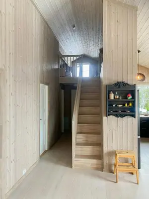 a staircase in a house with a wooden wall at New Cabin With Mountain View In Bittermark, Trysil in Trysil
