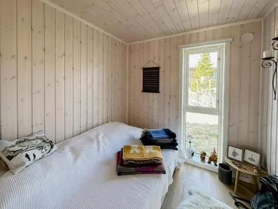 a bedroom with a bed in a room with a window at Cozy Cabin In Beautiful Area Near Lillehammer in Lillehammer