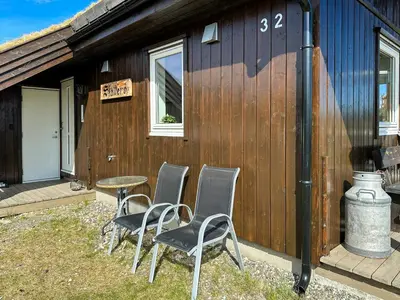 a group of chairs and a table in front of a building at Cozy Cabin In Beautiful Area Near Lillehammer in Lillehammer