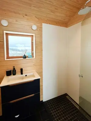 a bathroom with a sink and a window at Architect-Designed Cabin By Rondane in Høvringen