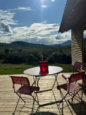 a table with a cake on top of it on a porch at Architect-Designed Cabin By Rondane in Høvringen