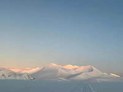 a group of snow covered mountains in the distance at Architect-Designed Cabin By Rondane in Høvringen