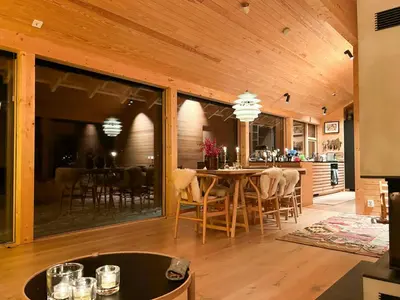 a kitchen and dining room with a table and chairs at Architect-Designed Cabin By Rondane in Høvringen