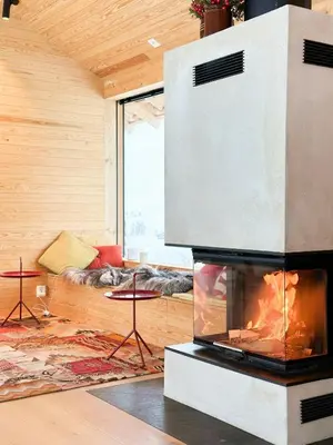 a living room with a fireplace and a couch at Architect-Designed Cabin By Rondane in Høvringen