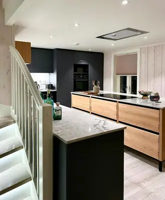 a kitchen with a black island in a kitchen at Charming & Modern Seaside House In Valsøyfjord in Valsøyfjord