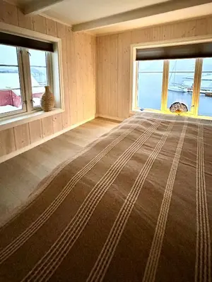 a room with two windows and a large rug at Charming & Modern Seaside House In Valsøyfjord in Valsøyfjord