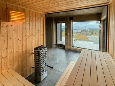 a room with wooden walls and a window and a bench at Architect Mountain Cabin At Lygna With Views in Jaren