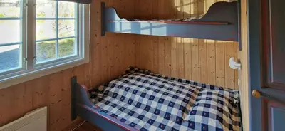 a room with a bed in a room with a window at Charming Cabin With Views In Valdres in Aurdal