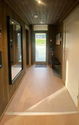 an empty hallway with a door and a room with a hallwayngth at Lovely, New Apartment At Kvitfjell With Ski-In Out in Fåvang