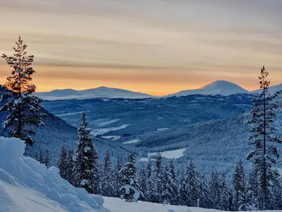 a winter view of the mountains with snow and trees at Modern Cabin With Panoramic View On Bringsfjellet in Lalm