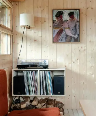 a living room with a book shelf with records at Architectural Gem Near Cross Country Trails in Eggedal